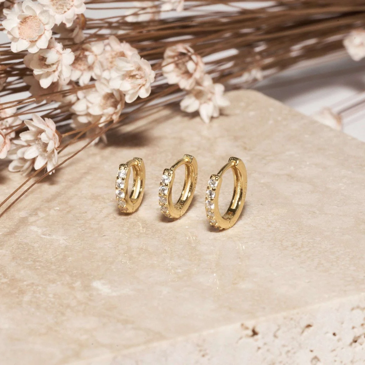 Crystal Paved Huggie Hoops In Gold - Image 4