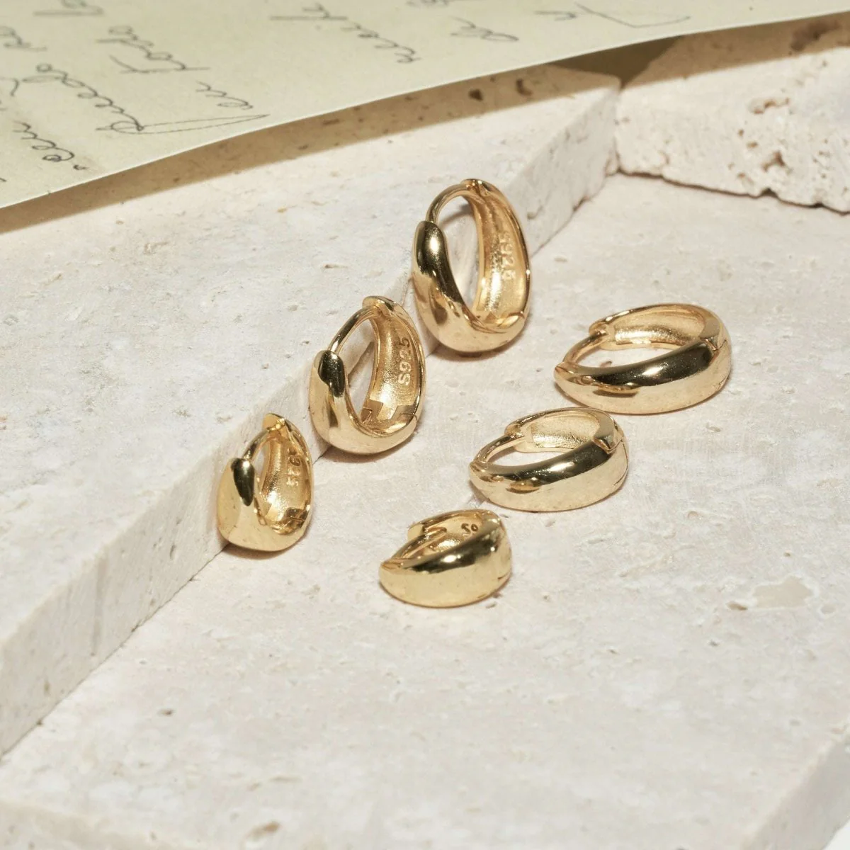 Tapered Huggie Hoops In Gold - Image 4