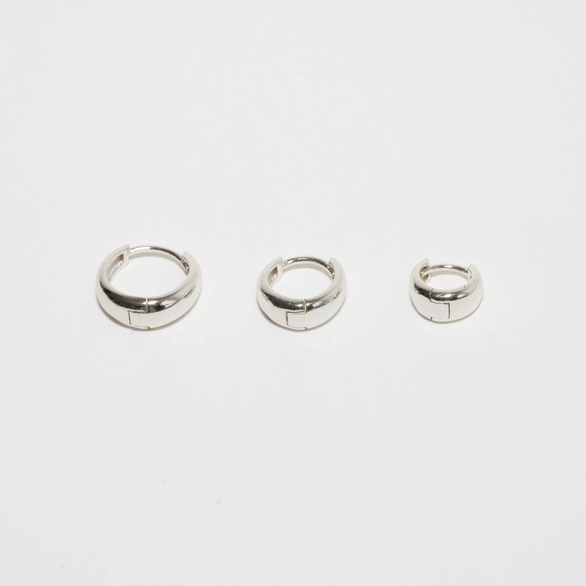 Tapered Huggie Hoops In Silver - Image 3