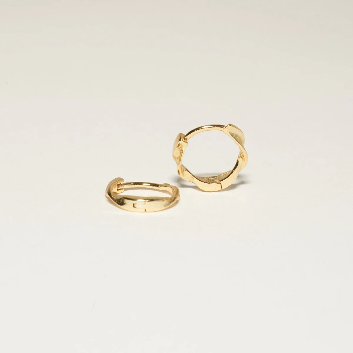 Twisted Huggie Hoops In Gold - Image 6